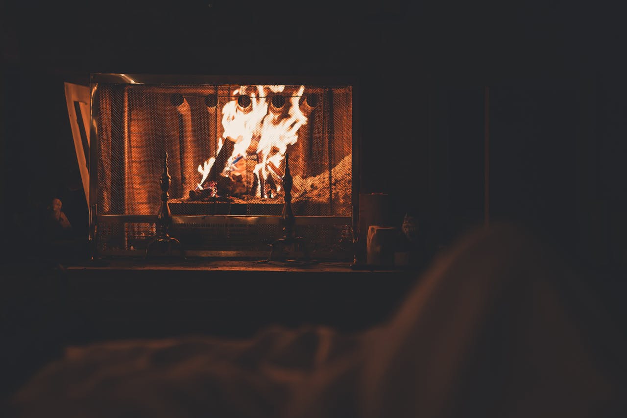 A cozy indoor fireplace with vivid flames, offering a warm and relaxing winter ambiance.